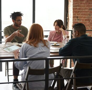 4 people having a discussion at a table