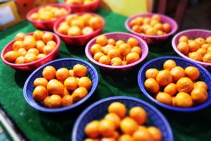 multiple bowls of small fruits